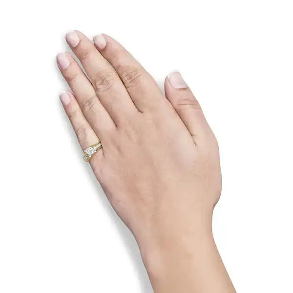 Human hand wearing a diamond ring on the ring finger.